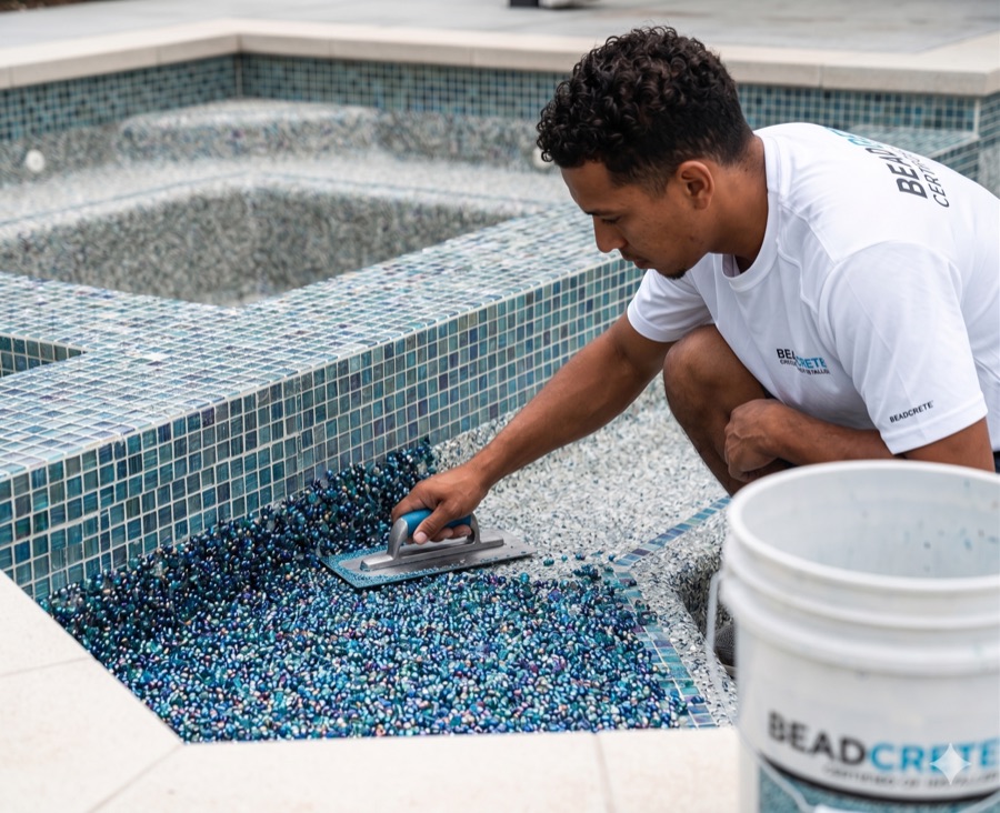 Beadcrete specialist applying a premium pool interior